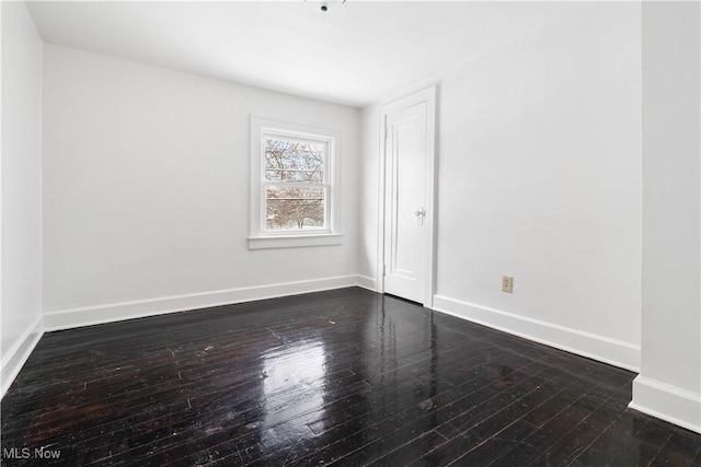 spare room featuring dark hardwood / wood-style flooring