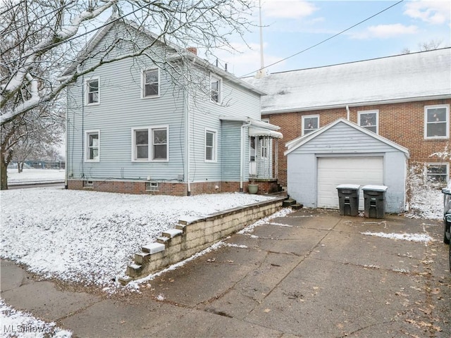 view of front of property with an outdoor structure and a garage