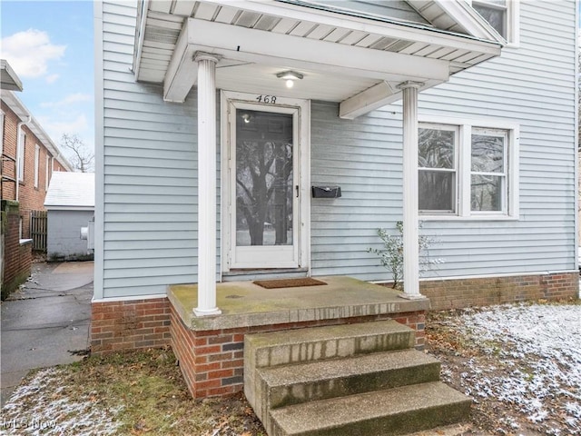 view of snow covered property entrance