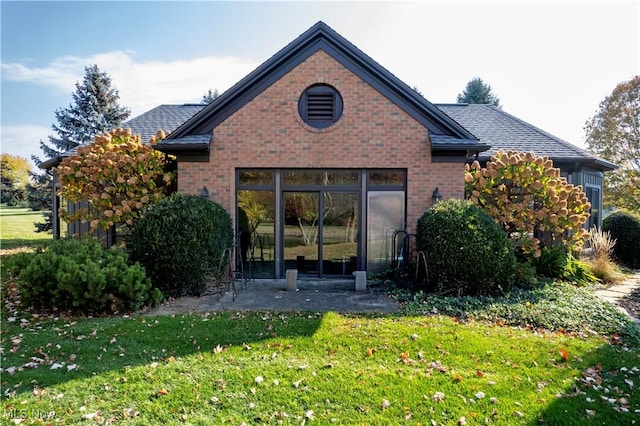 rear view of house with a lawn