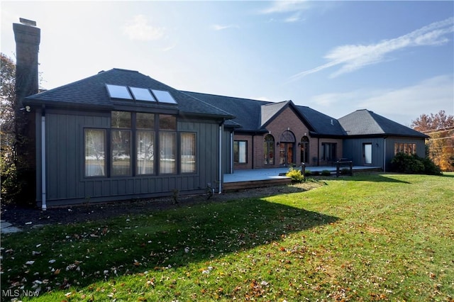 rear view of property featuring a yard