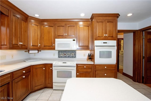 kitchen featuring white appliances and light tile patterned floors