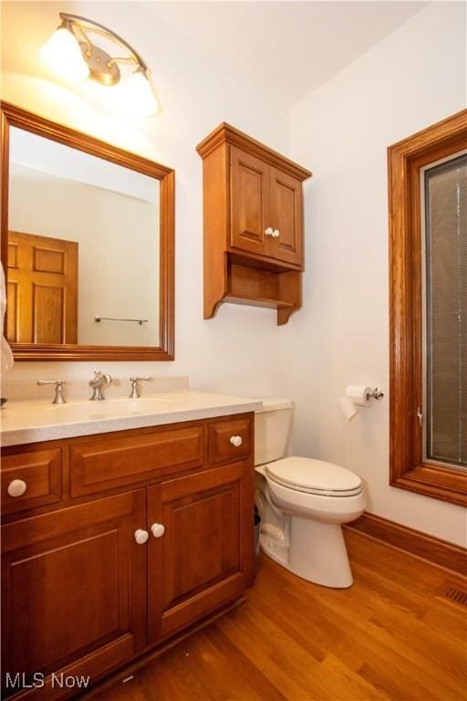 bathroom featuring vanity, toilet, and wood-type flooring