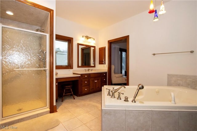 bathroom featuring tile patterned floors, vanity, and shower with separate bathtub