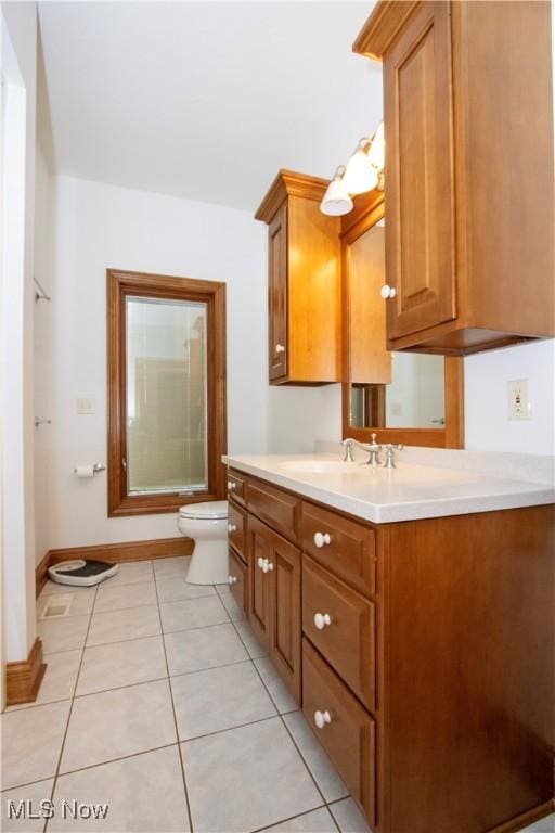 full bathroom featuring tile patterned floors, vanity, toilet, and combined bath / shower with glass door