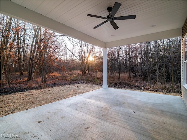 patio terrace at dusk featuring ceiling fan