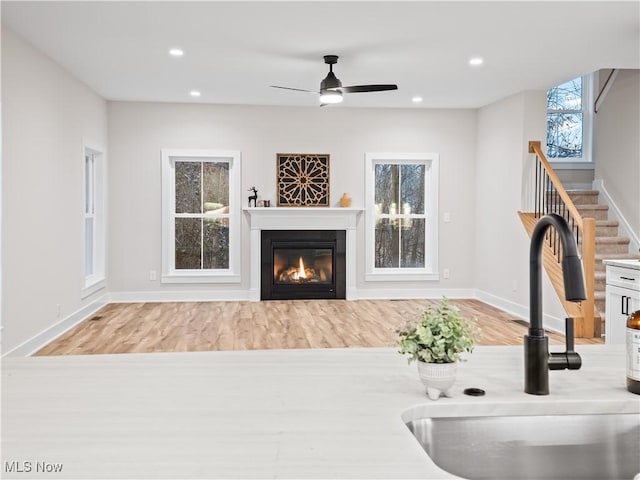 interior space featuring light hardwood / wood-style flooring, ceiling fan, and sink