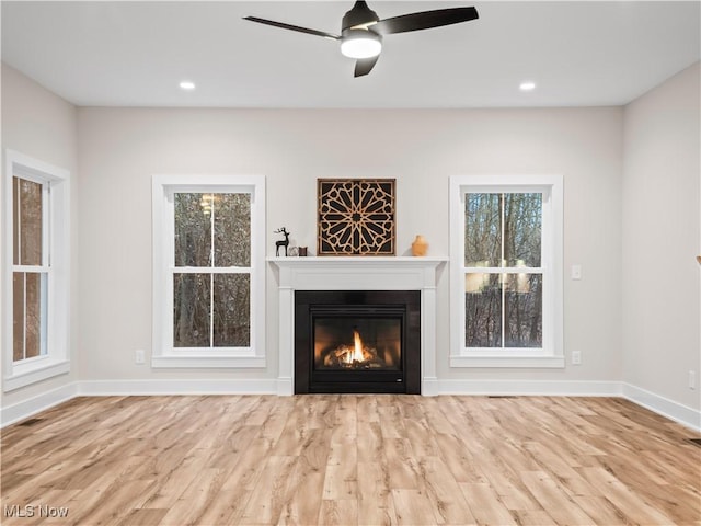 unfurnished living room featuring light hardwood / wood-style floors and ceiling fan