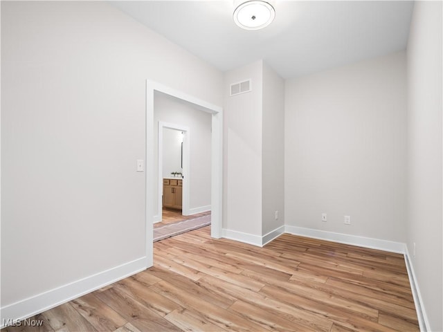 spare room featuring light hardwood / wood-style floors