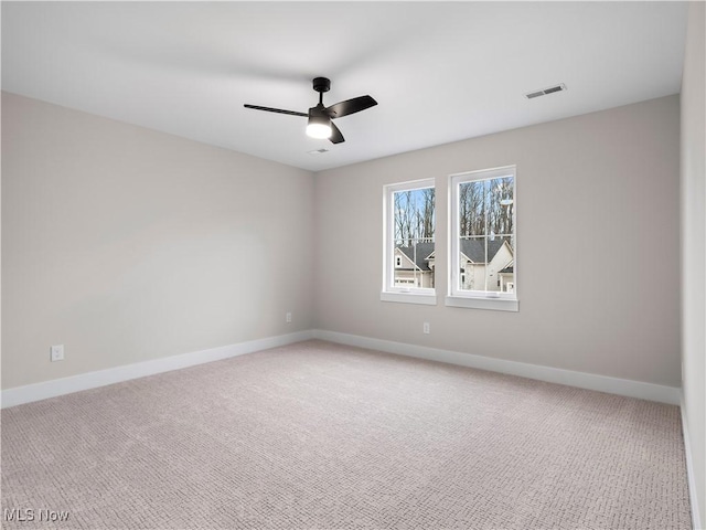 empty room featuring carpet flooring and ceiling fan