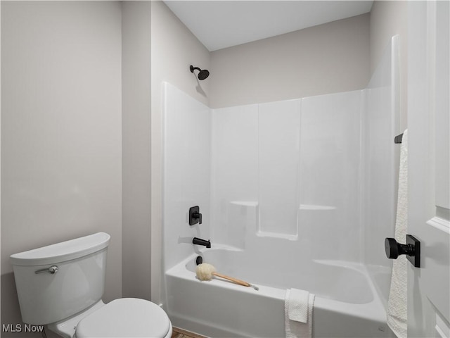 bathroom featuring shower / bathing tub combination and toilet