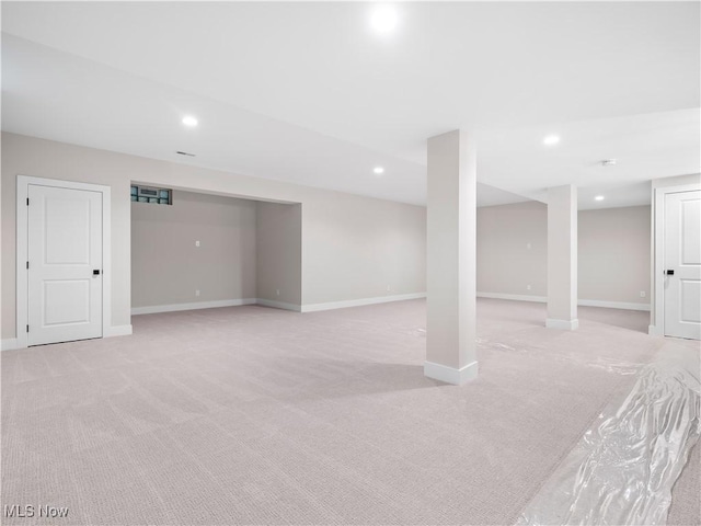 basement featuring light colored carpet