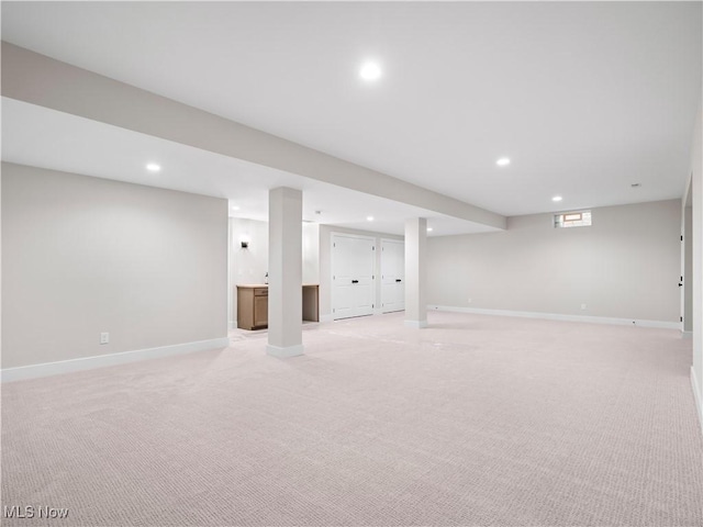 basement featuring light carpet