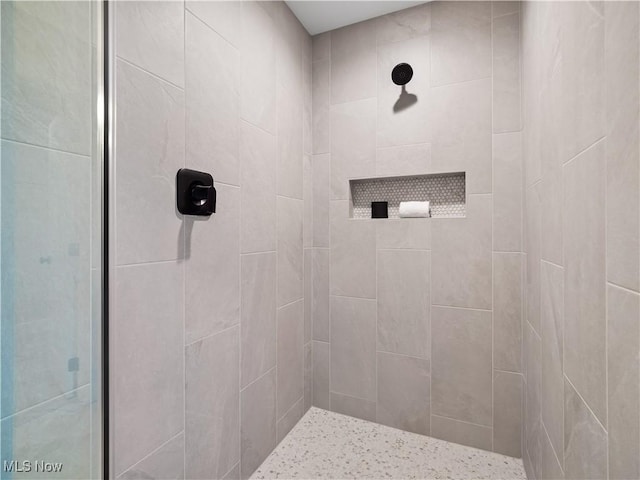 bathroom with a tile shower