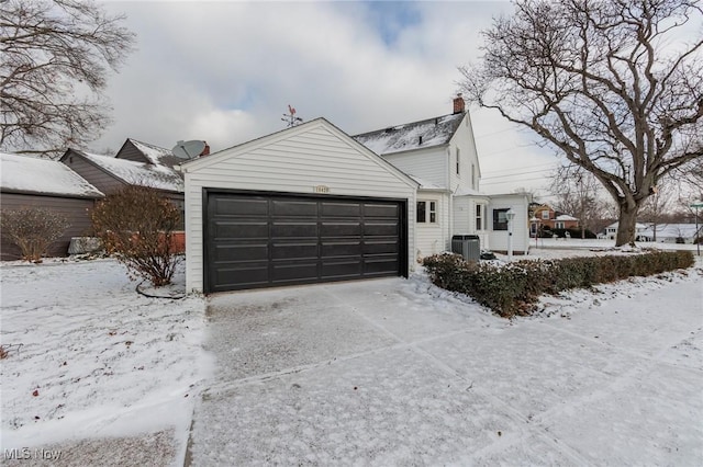 exterior space with a garage and central air condition unit