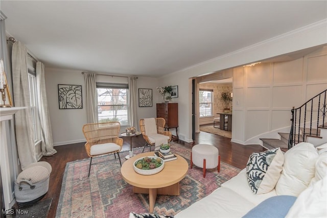 living room featuring dark hardwood / wood-style floors and ornamental molding