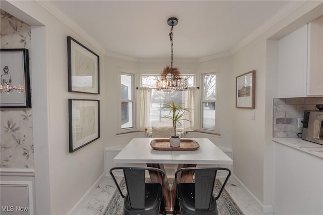 dining room featuring crown molding, plenty of natural light, and a notable chandelier