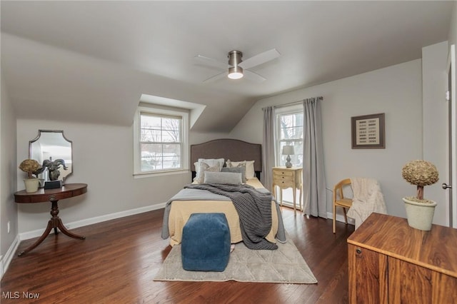 bedroom featuring multiple windows, ceiling fan, dark wood-type flooring, and lofted ceiling