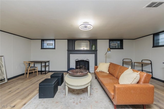 living room featuring hardwood / wood-style flooring, a fireplace, and a wealth of natural light