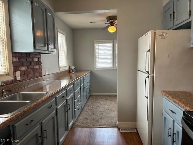 kitchen featuring gray cabinets and sink