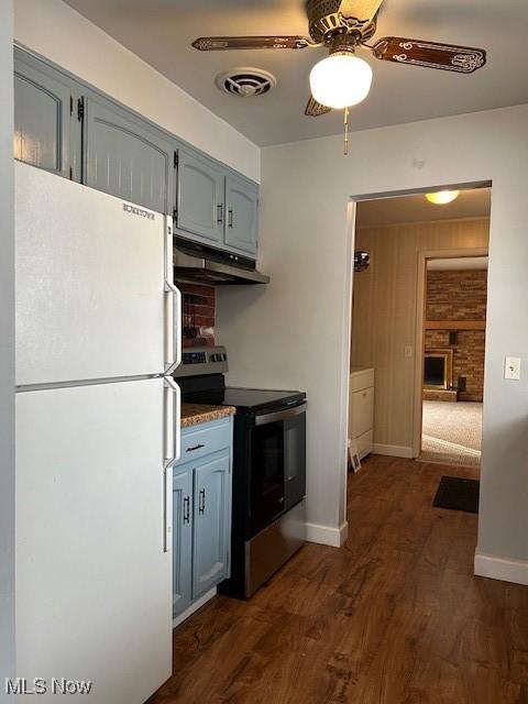 kitchen featuring stainless steel range with electric cooktop, dark hardwood / wood-style floors, ceiling fan, and white fridge