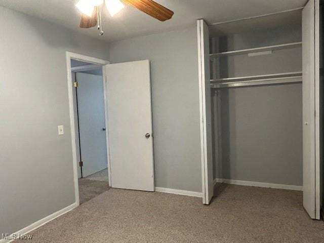 unfurnished bedroom with light carpet, a closet, and ceiling fan