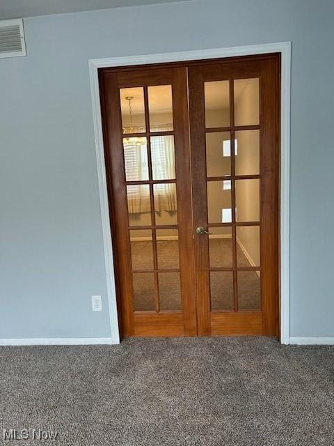 interior details with a baseboard radiator, carpet, and french doors