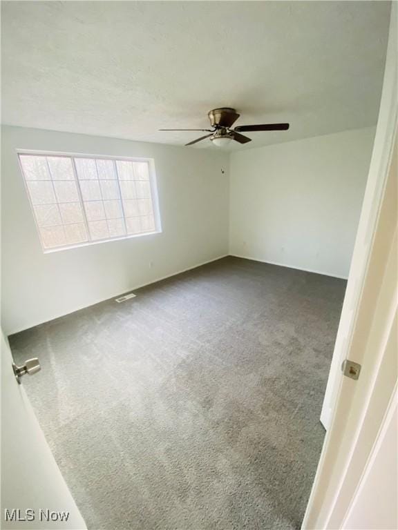 carpeted empty room with ceiling fan