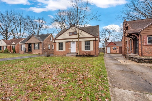 view of front of house featuring a garage, a front lawn, and an outdoor structure