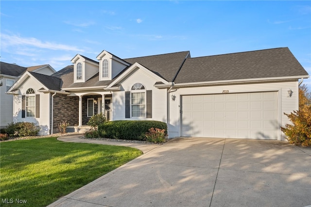 view of front of home with a garage and a front lawn