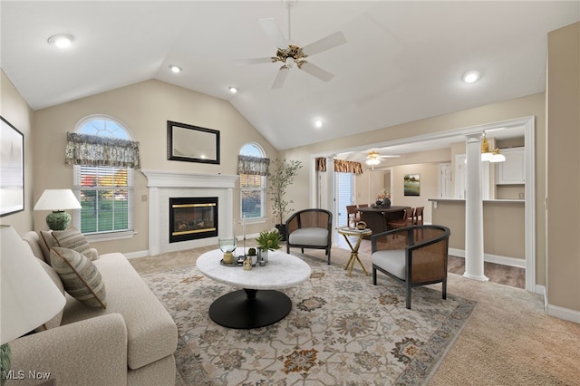 carpeted living room featuring ceiling fan, lofted ceiling, and decorative columns