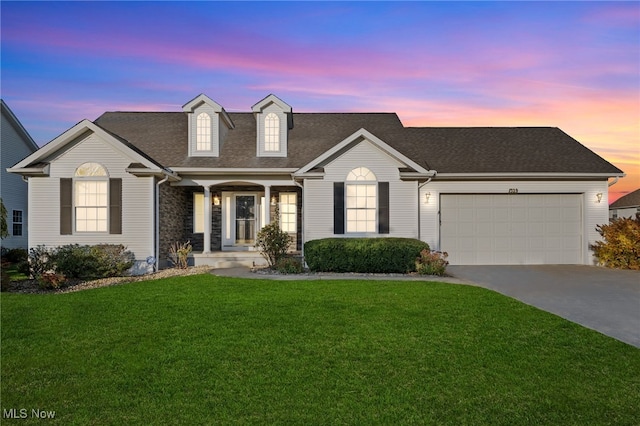 view of front of home with a lawn and a garage