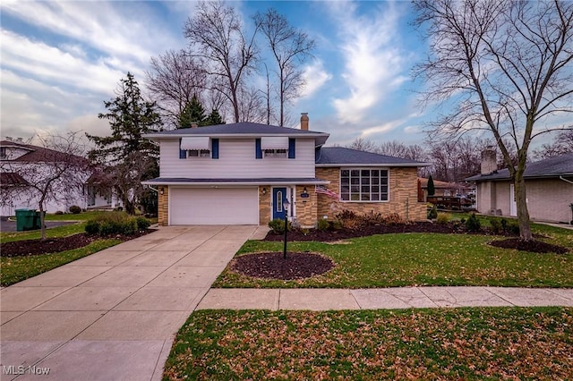 tri-level home featuring a garage and a front yard