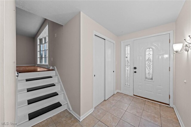 foyer entrance featuring light tile patterned flooring