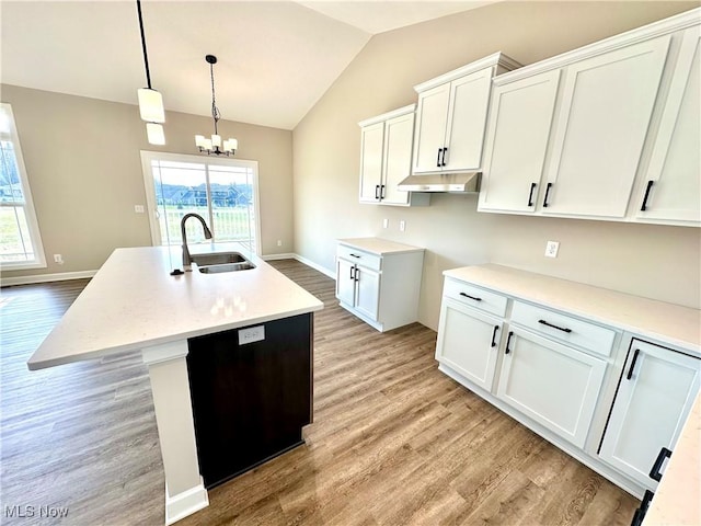 kitchen with white cabinets, an island with sink, a healthy amount of sunlight, and sink