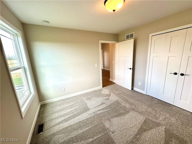 unfurnished bedroom with carpet floors and a closet