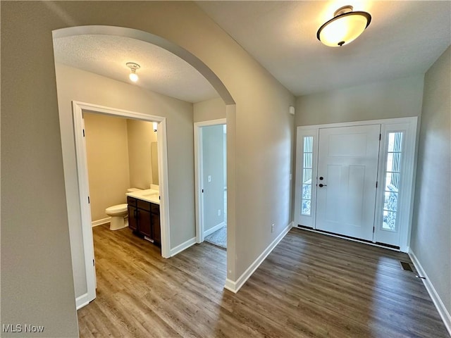 entrance foyer featuring hardwood / wood-style floors and a textured ceiling