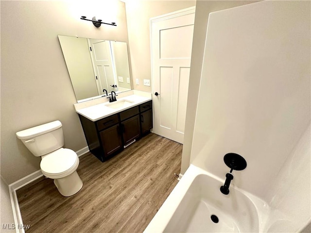 bathroom featuring vanity, toilet, and wood-type flooring