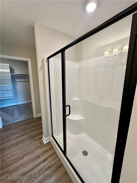 bathroom featuring hardwood / wood-style floors and an enclosed shower