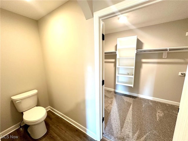 bathroom featuring hardwood / wood-style floors and toilet