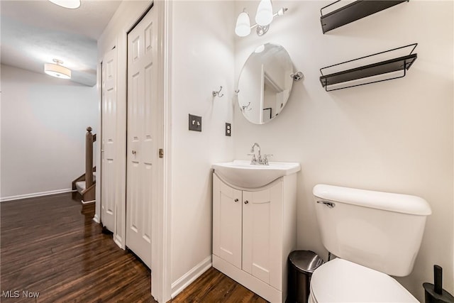 bathroom featuring hardwood / wood-style floors, vanity, and toilet