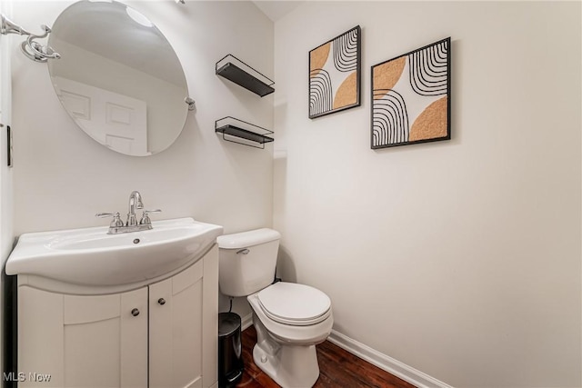 bathroom with hardwood / wood-style floors, vanity, and toilet