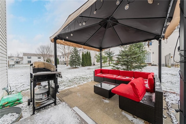 snow covered patio featuring an outdoor hangout area