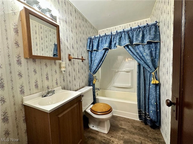 full bathroom with vanity, toilet, shower / bathtub combination with curtain, and hardwood / wood-style flooring