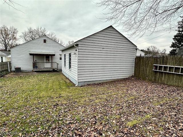 rear view of house with a yard and cooling unit