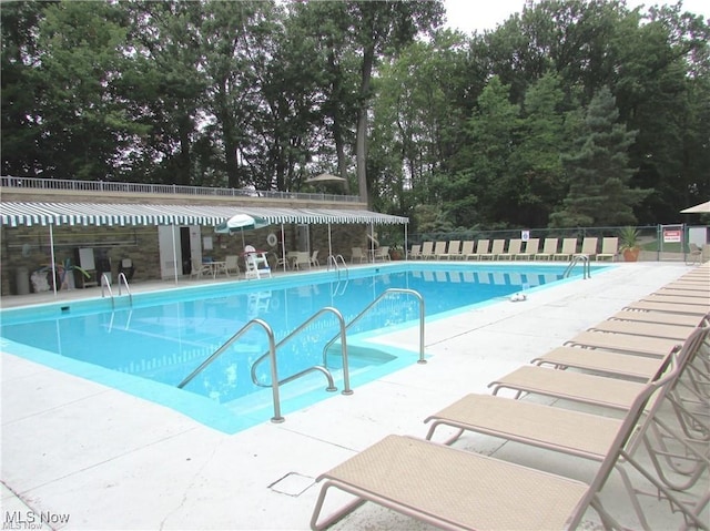 view of swimming pool with a patio