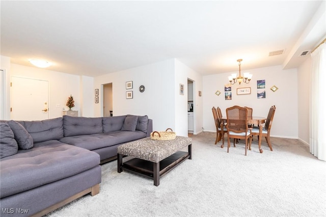 living room with carpet and an inviting chandelier