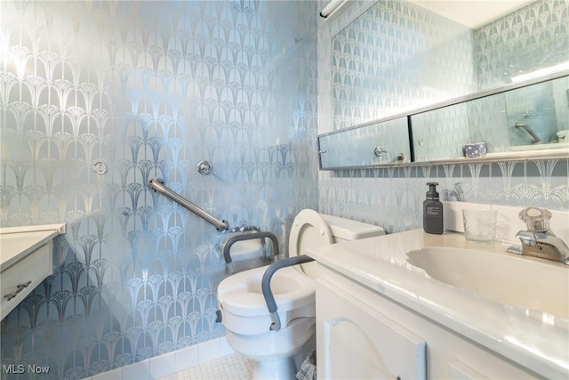 bathroom with tile patterned flooring, vanity, and toilet