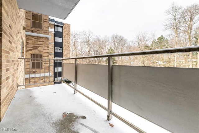 view of snow covered back of property