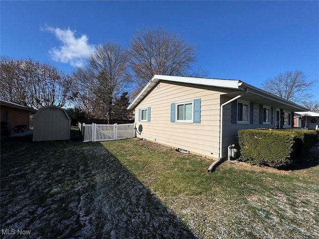 view of home's exterior featuring a yard and a storage unit